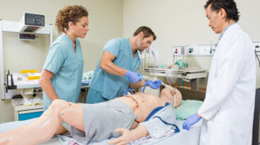 students practicing on mannequin